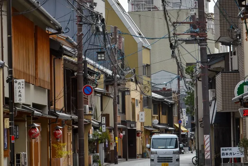 Quiet Kyoto street lined with wooden townhouses